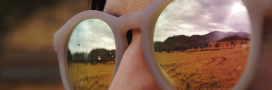 Woman with sunglasses looking at mountains